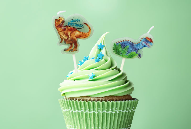 Verjaardagsmuffin met dinosauruskaarsjes